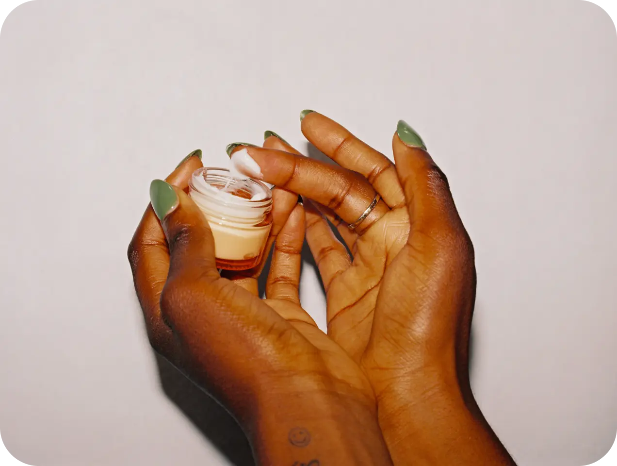 Black hands testing out a cream
